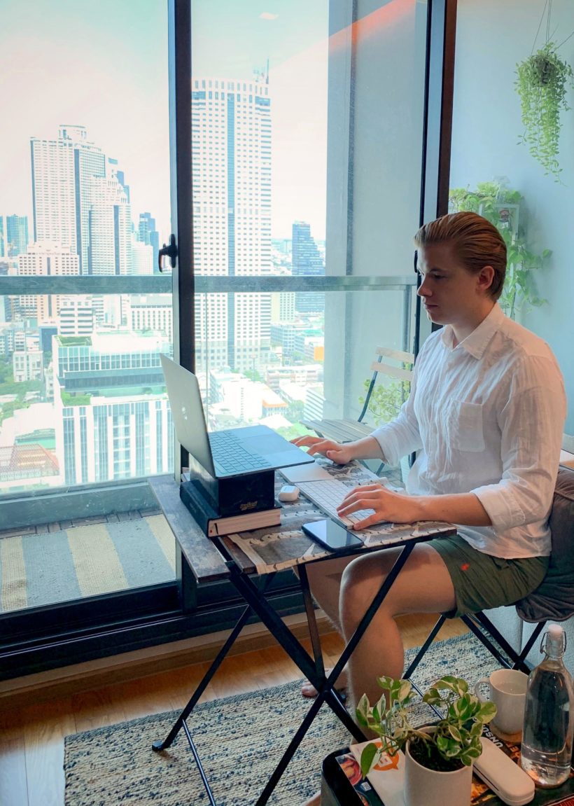 Tuukka sitting in his home office with a view. 