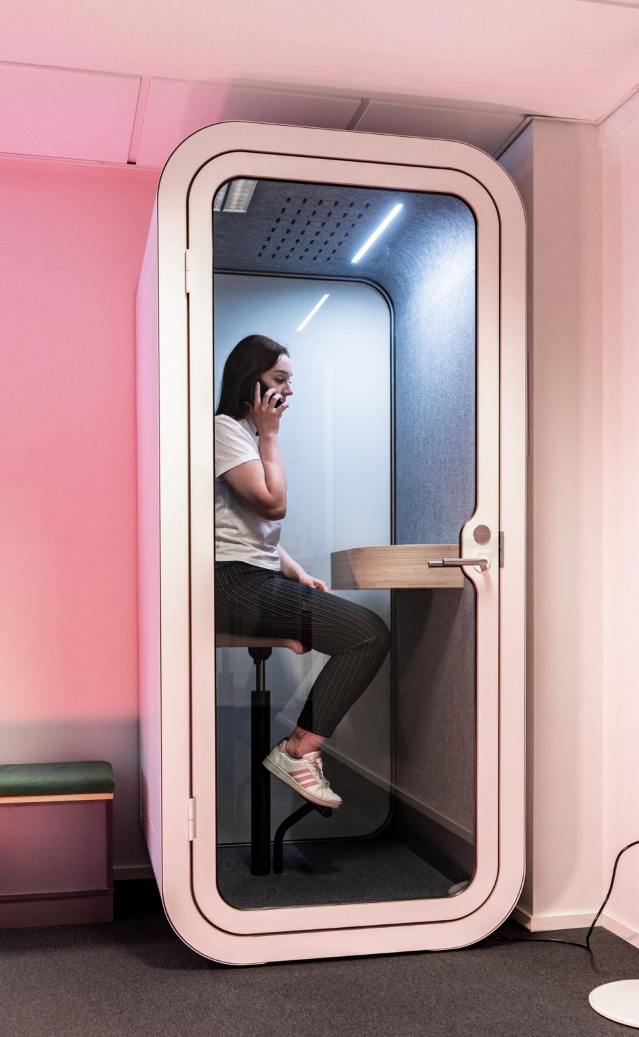 Woman sitting in Framery O soundproof office pod