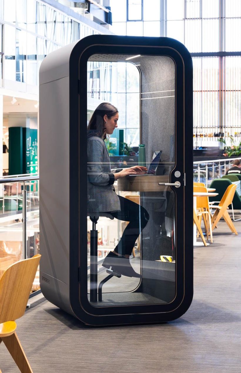 Person working in gray Framery O office pod
