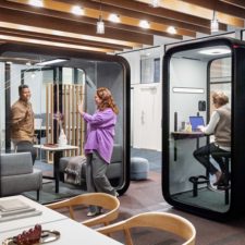 People working in open office with Framery pods