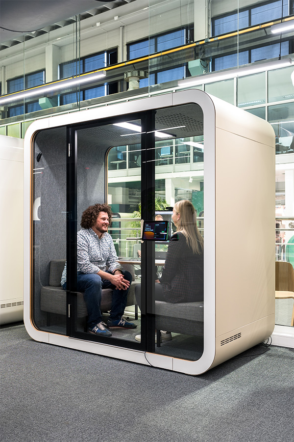 Two people having a meeting in a Framery Q meeting pod.