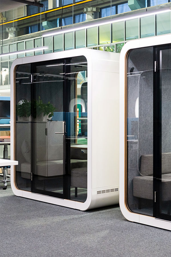 Two Framery Q meeting pods in a row in an open-plan office.