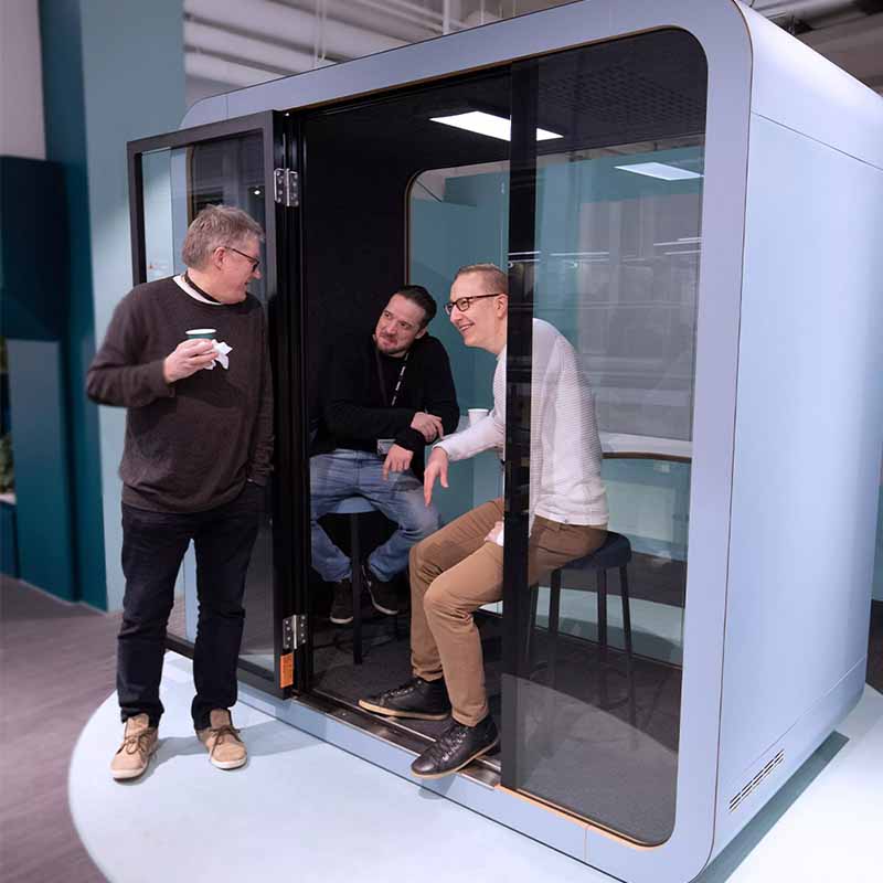 People having a chat in a Framery meeting pod.