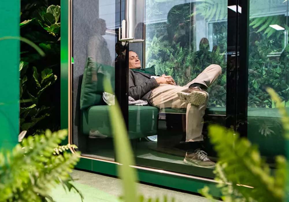 Person taking a nap in a framery q pod.
