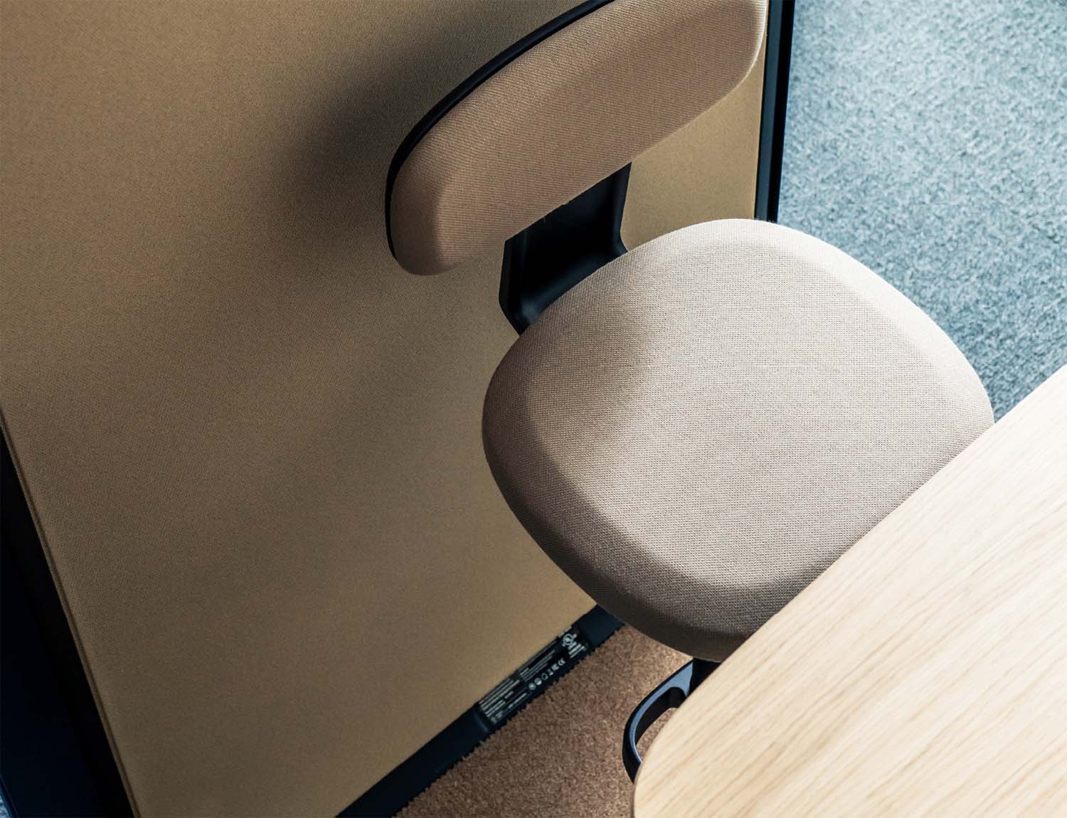 Closer look inside Framery One soundproof office pod's interior with a comfortable chair and height adjustable table.