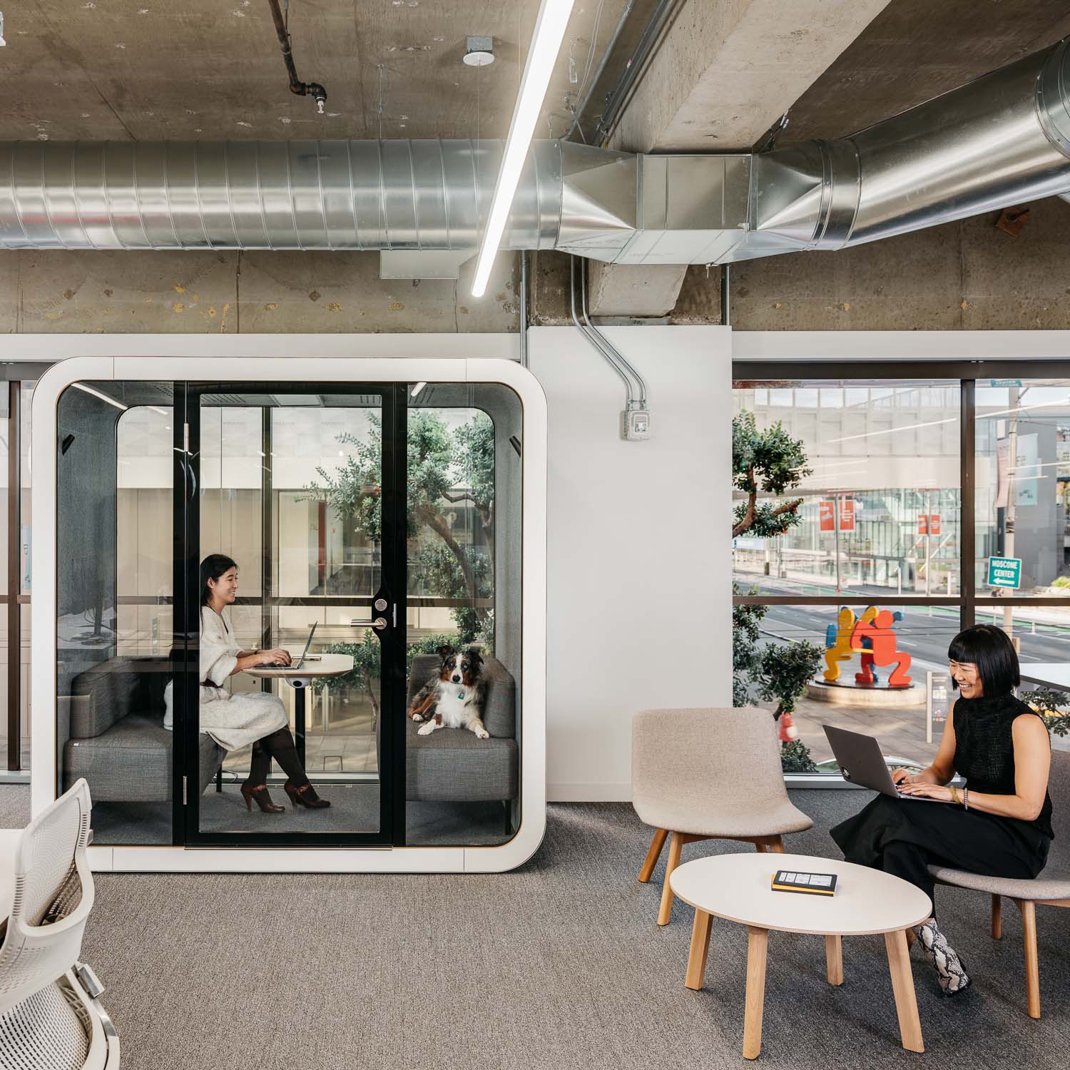 People working in Postmates office with one person working in a Framery Q meeting pod.