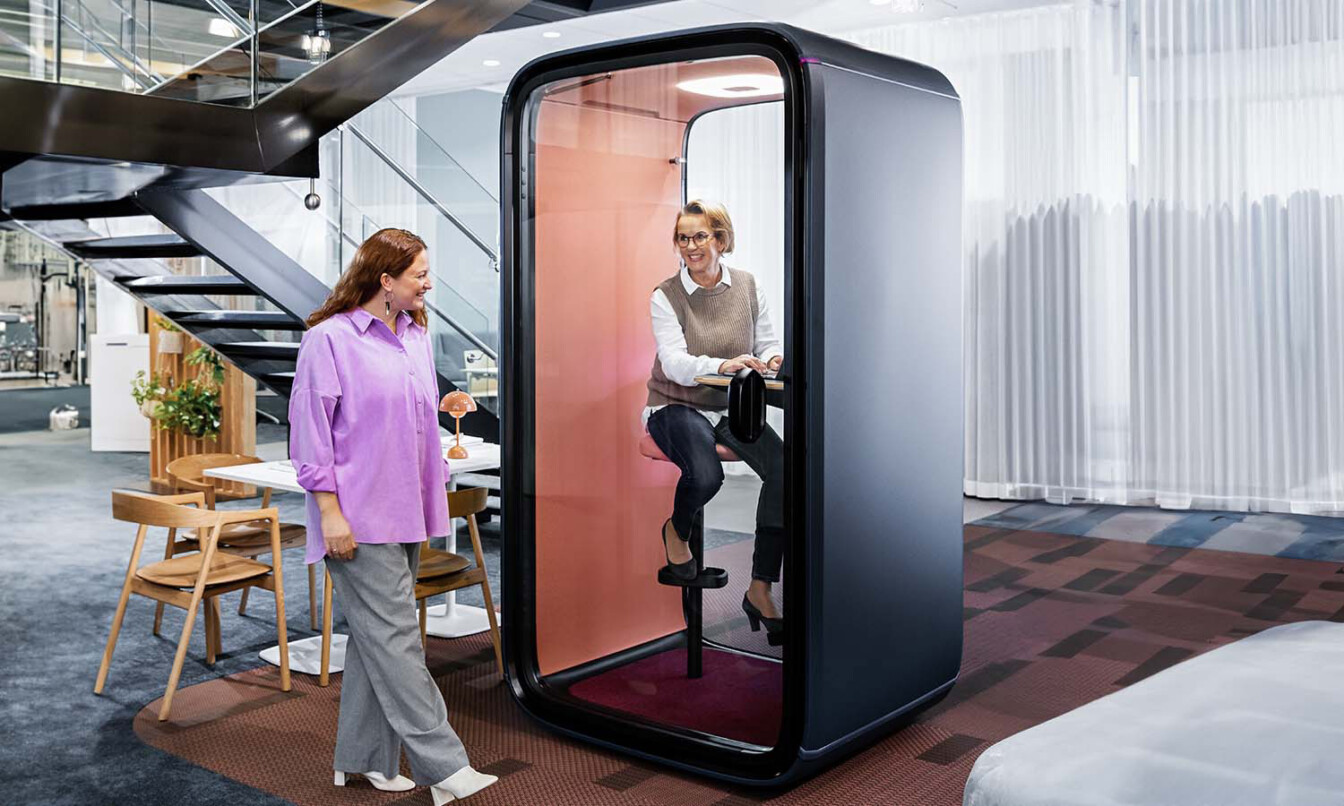 A person working in a Framery One office pod in an open plan office.